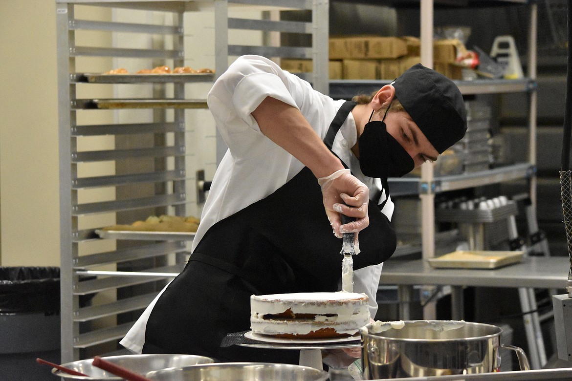 Daylen Callahan ices his cake during the SkillsUSA regional commercial baking contest held at CB Tech on Feb. 11.