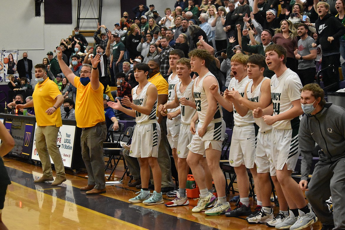 The entire Quincy bench erupted in cheers and shock as Aidan Heikes made the winning shot at the district championship on Feb. 11.