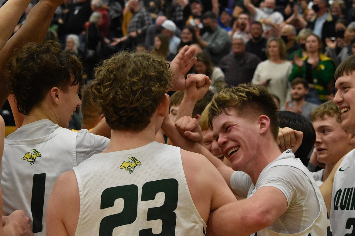 Quincy High School senior Aidan Heikes, right, smiles as he embraces his teammates after winning the District 6 Championship game.