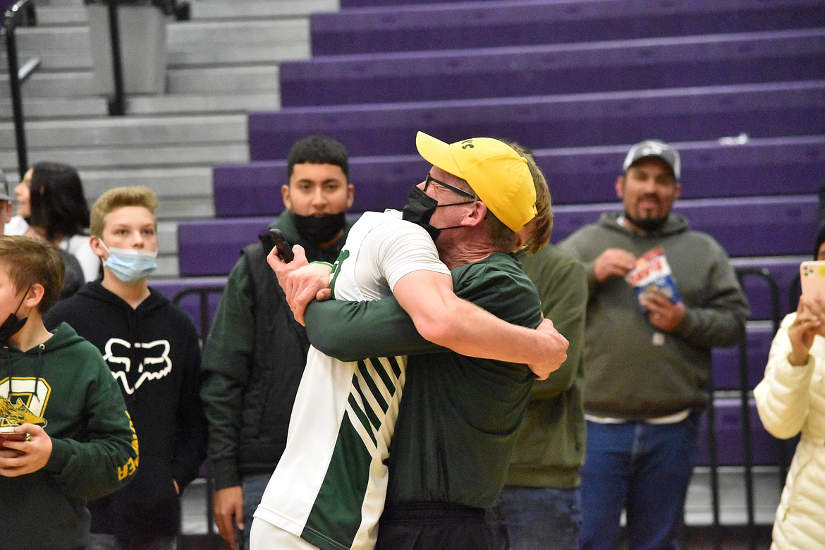 Todd Heikes embraces his son, Aidan Heikes (30), after the district title game.