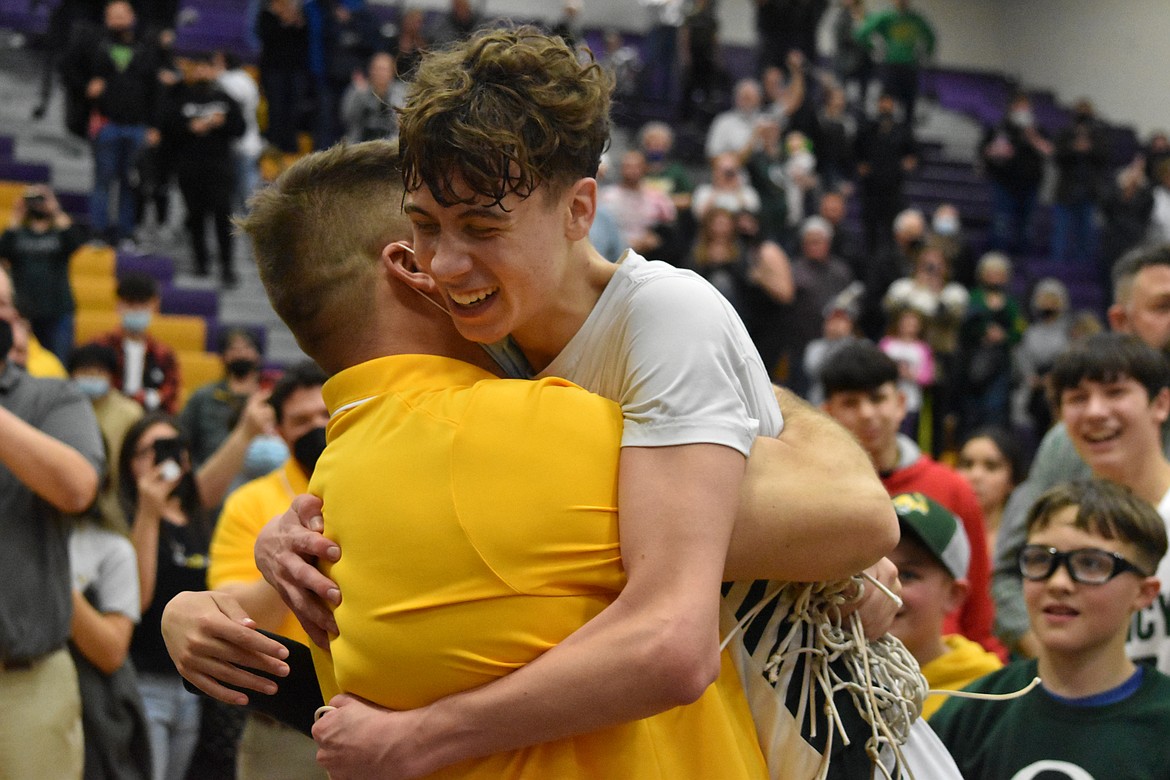 Coach Scott Bierlink hugs his son, TreyVaughn Bierlink after cutting the net at Wenatchee High School on Feb. 11.