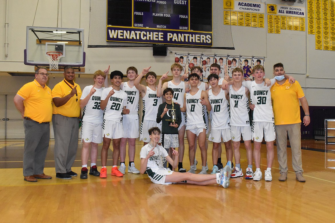 The 2021-22 Quincy High School boys basketball team holds the league title and now the district title as well.