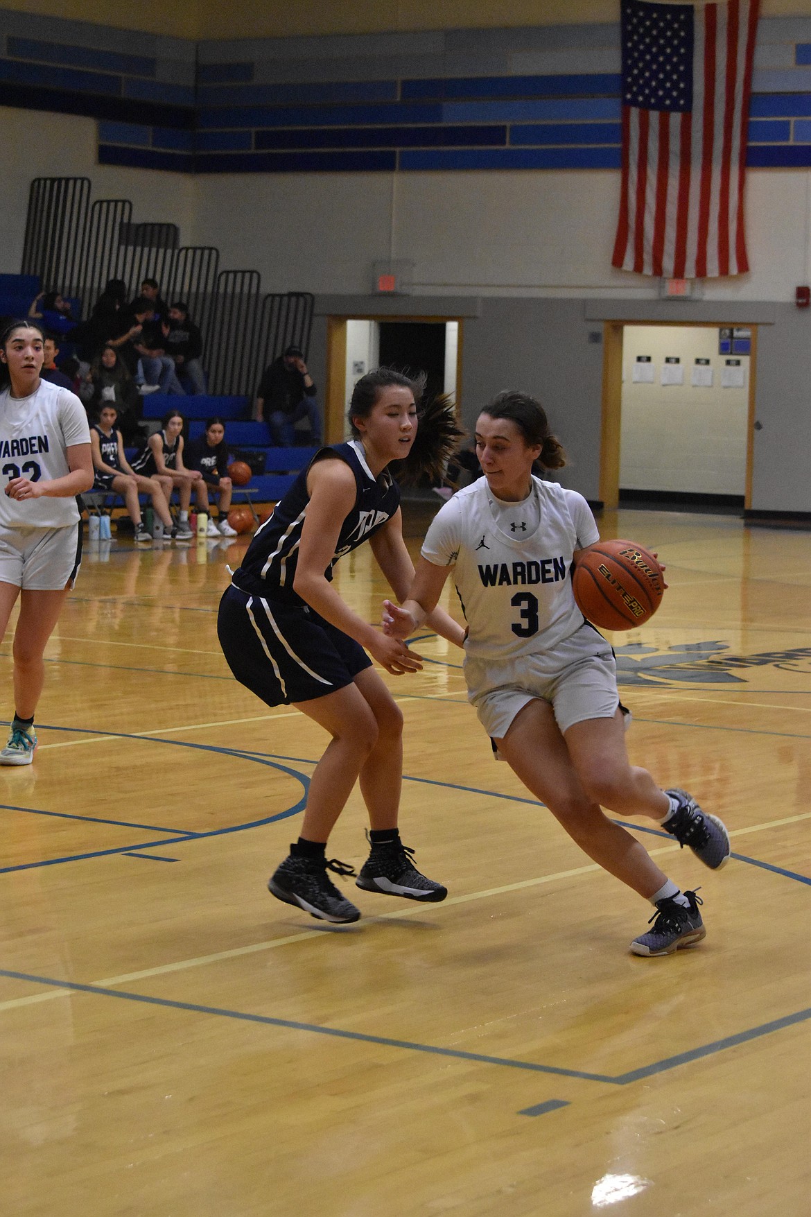 Warden High School junior Quinn Erdmann (3) drives past a Tri-Cities Prep opponent during the district matchup on Feb. 12 at Warden High School.