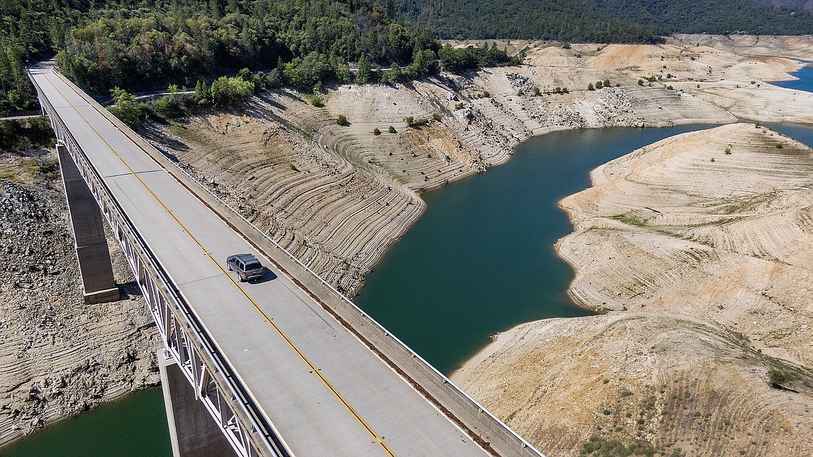 A car crosses Enterprise Bridge over Lake Oroville's dry banks on May 23, 2021, in Oroville, Calif. The American West's megadrought deepened so much last year that it is now the driest it has been in at least 1200 years and a worst-case scenario playing out live, a new study finds. (AP Photo/Noah Berger, File)