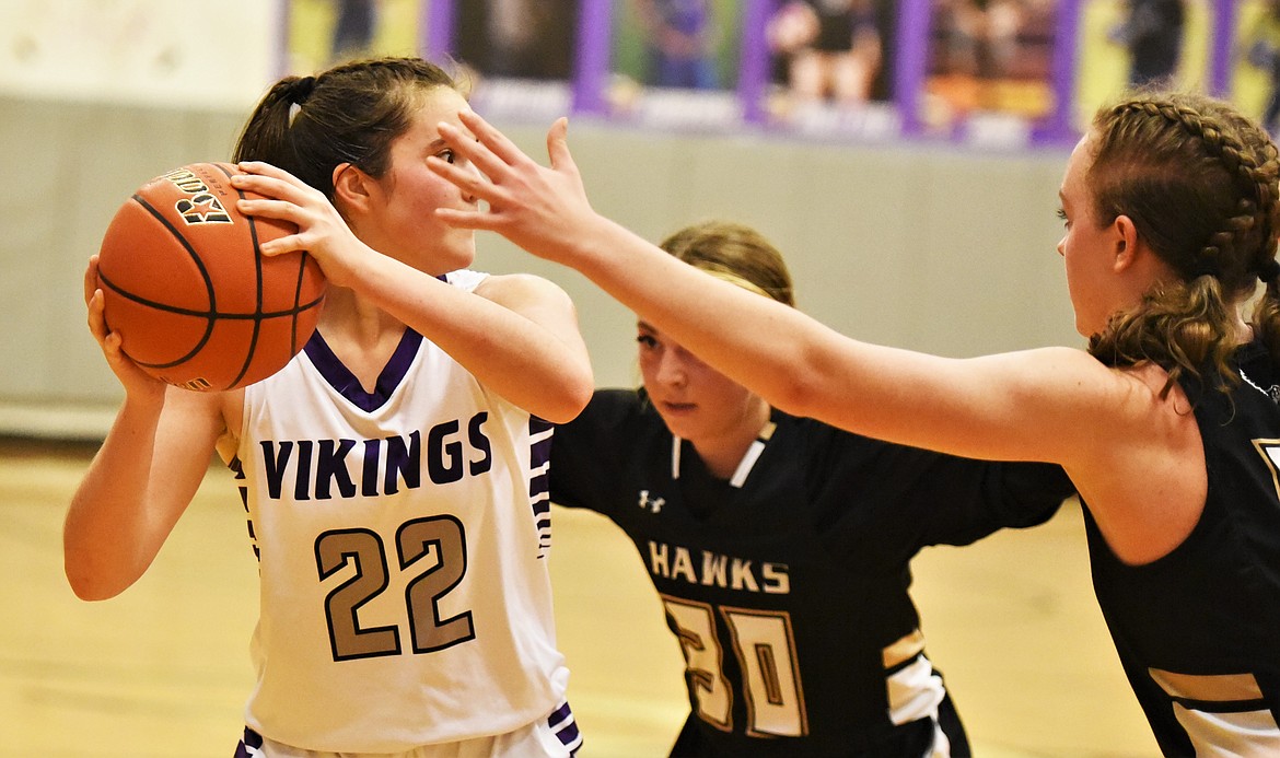 Charlo's Mila Hawk looks to pass out of a double team from Seeley-Swan. (Scot Heisel/Lake County Leader)