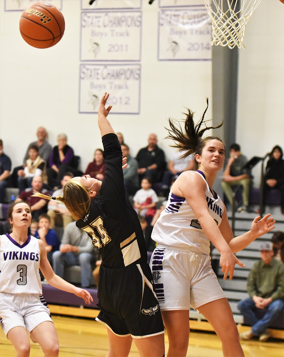 Charlo's Mila Hawk swats away a shot by Seeley-Swan's Tegan Mauldin. (Scot Heisel/Lake County Leader)