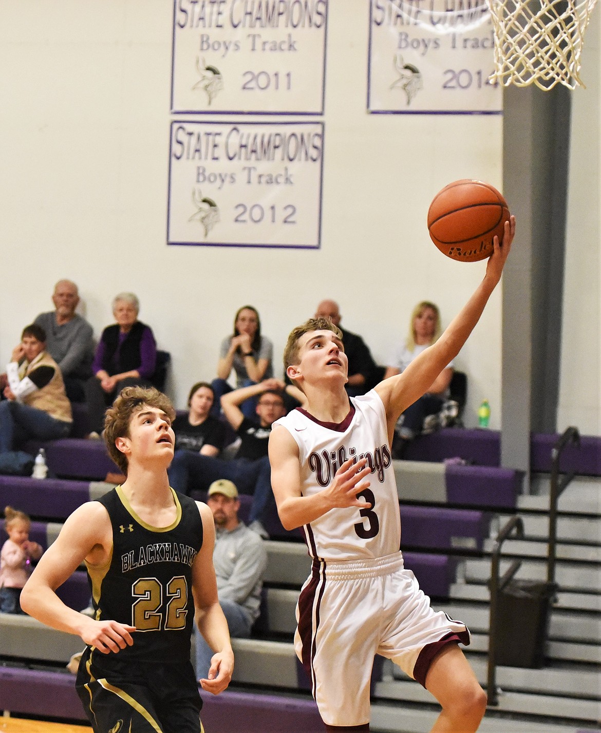 Hayden Hollow puts up a shot on a fast break in front of Chase Haines. (Scot Heisel/Lake County Leader)