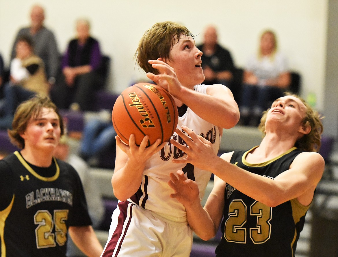 Charlo's Tucker Love rises above Seeley-Swan defenders Jason James (23) and Walker McDonald. (Scot Heisel/Lake County Leader)