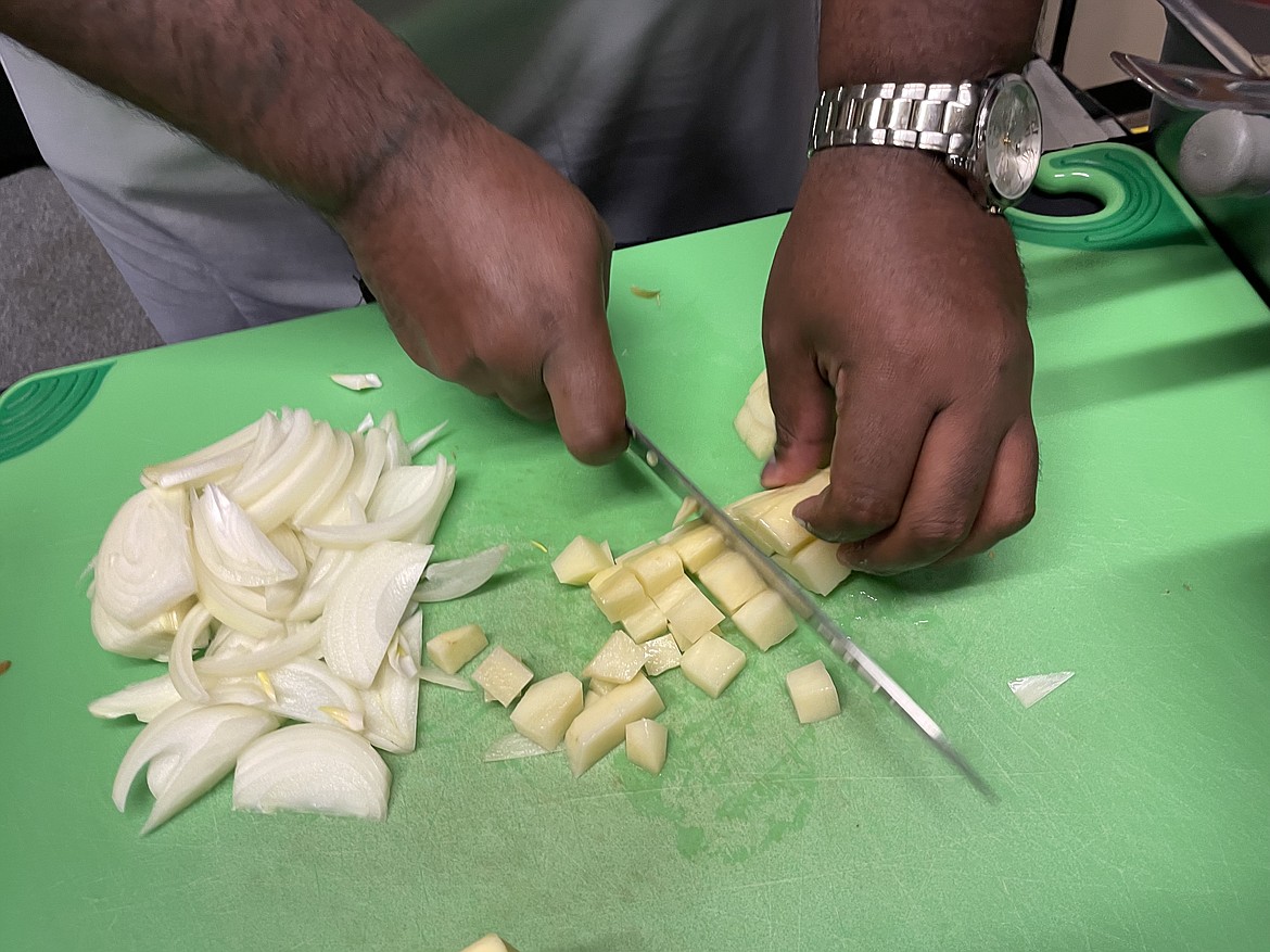 Chef RJ Harvey dicing a potato.