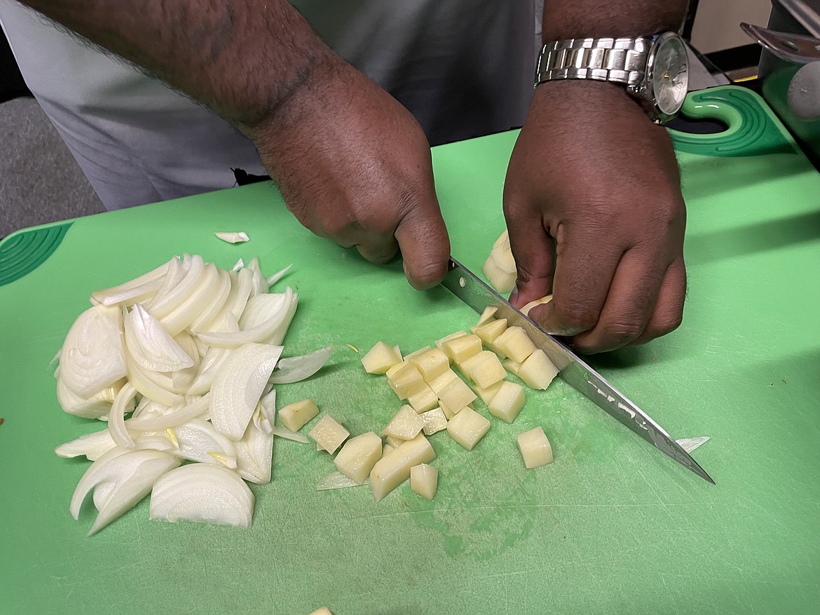 Chef RJ Harvey dicing a potato.