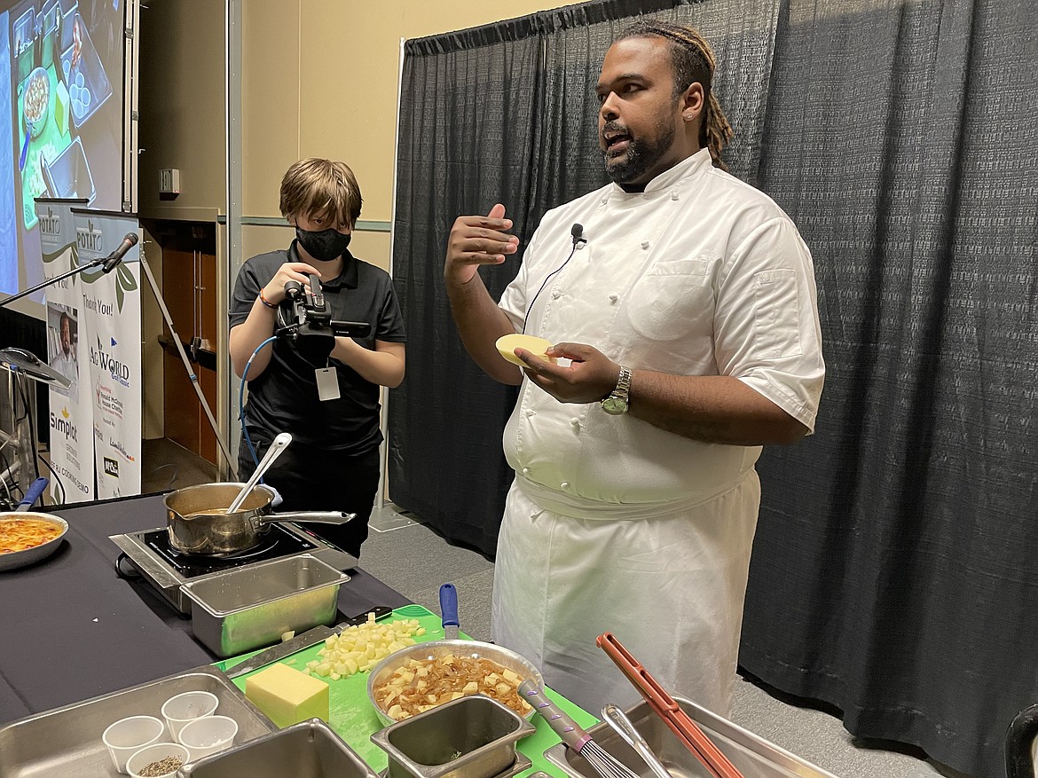 Chef RJ Harvey, culinary director for Potatoes USA, prepares to show how best to dice a potato and peel an onion to make French Onion Potato Casserole during the annual Washington Oregon Potato Conference in Kennewick last week.