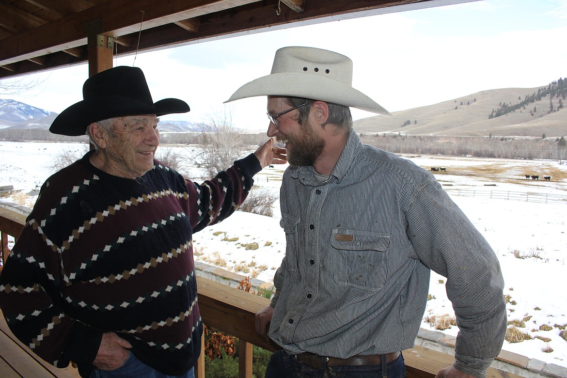 Gerald Lee "Jerry" Hamel, left, has a good laugh with Matthew Whyatt on the deck of Hamel's home. Hamel is being inducted into the Montana Cowboy Hall of Fame and Western Heritage Center in April. Whyatt is the Cattle Supervisor-North Herd, of the Hamel Valley Ranch in Dixon. (Monte Turner/Mineral Independent)