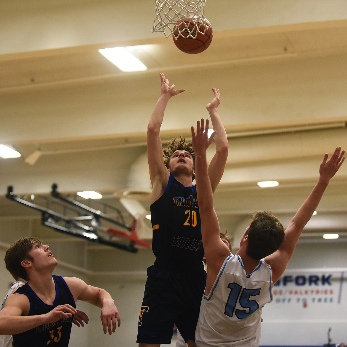 Josh Wihite pulls down a rebound over Bigfork's Bryce Gilliard Saturday. (Jeremy Weber/Bigfork Eagle)