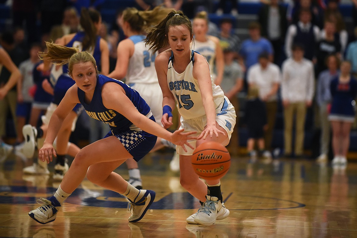 Chesney Lowe reaches in to steal the ball from Bigfork's Ava Davey in the second quarter Saturday. (Jeremy Weber/Bigfork Eagle)