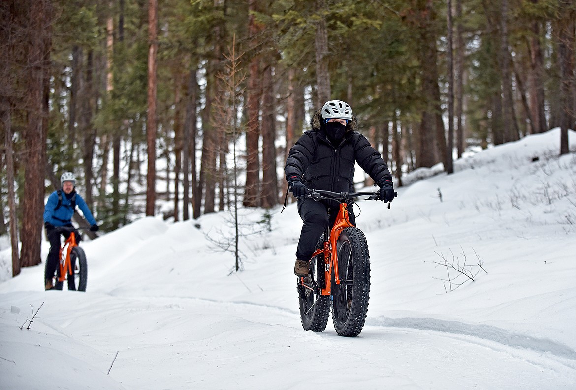 Guests at the Whitefish Bike Retreat, Linda and Lars Brekken, hit the freshly groomed trails on fat bikes near the Beaver Lakes area. (Whitney England/Whitefish Pilot)