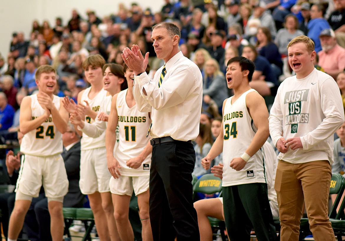 Whitefish head coach Scott Smith and the Bulldog bench celebrate as Whitefish scores against Columbia Falls in the fourth quarter on Saturday. (Whitney England/Whitefish Pilot)