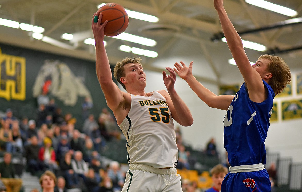 Whitefish senior Talon Holmquist hooks a shot up over a Columbia Falls defender in a game on Saturday afternoon. (Whitney England/Whitefish Pilot)