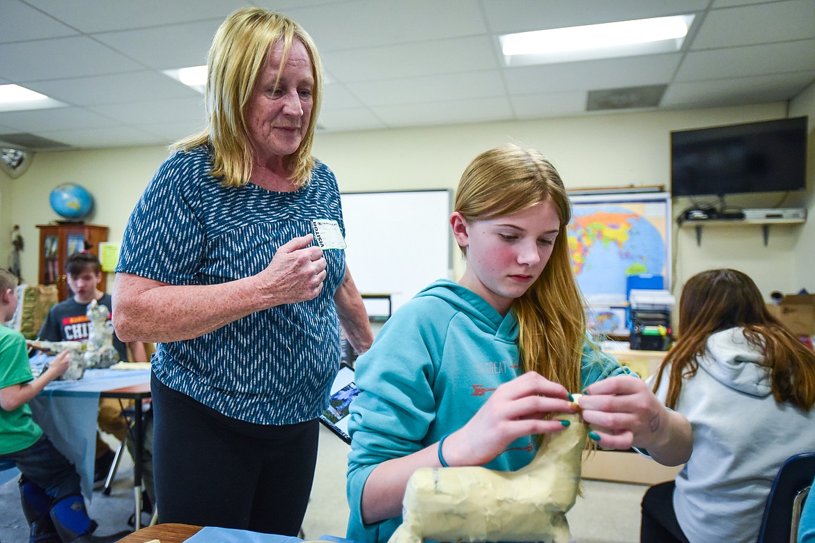 Nancy Roberts, left, helps seventh-grader Ella Rohletter with her paper mache project at Fair-Mont-Egan School on Tuesday, Feb. 15. (Casey Kreider/Daily Inter Lake)