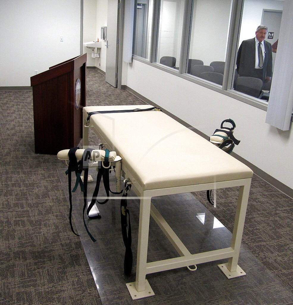 This Oct. 20, 2011 file photo shows the execution chamber at the Idaho Maximum Security Institution as Security Institution Warden Randy Blades look on in Boise, Idaho. Legislation that would bar Idaho officials from releasing where they obtain the drugs used in lethal injection executions was introduced by the House State Affairs Committee on Monday, Feb. 14, 2022. (AP Photo/Jessie L. Bonner, File)