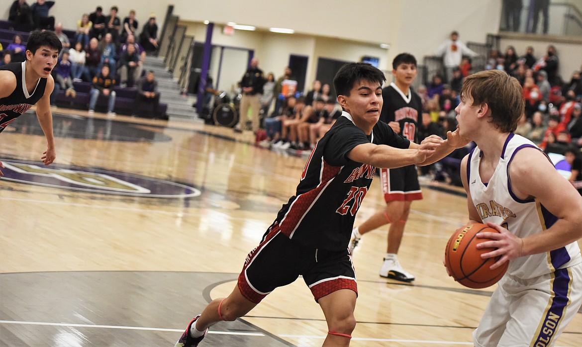 Polson's Dawson DuMont looks for a pass as Browning's Jamerson Lazy Boy defends. (Scot Heisel/Lake County Leader)