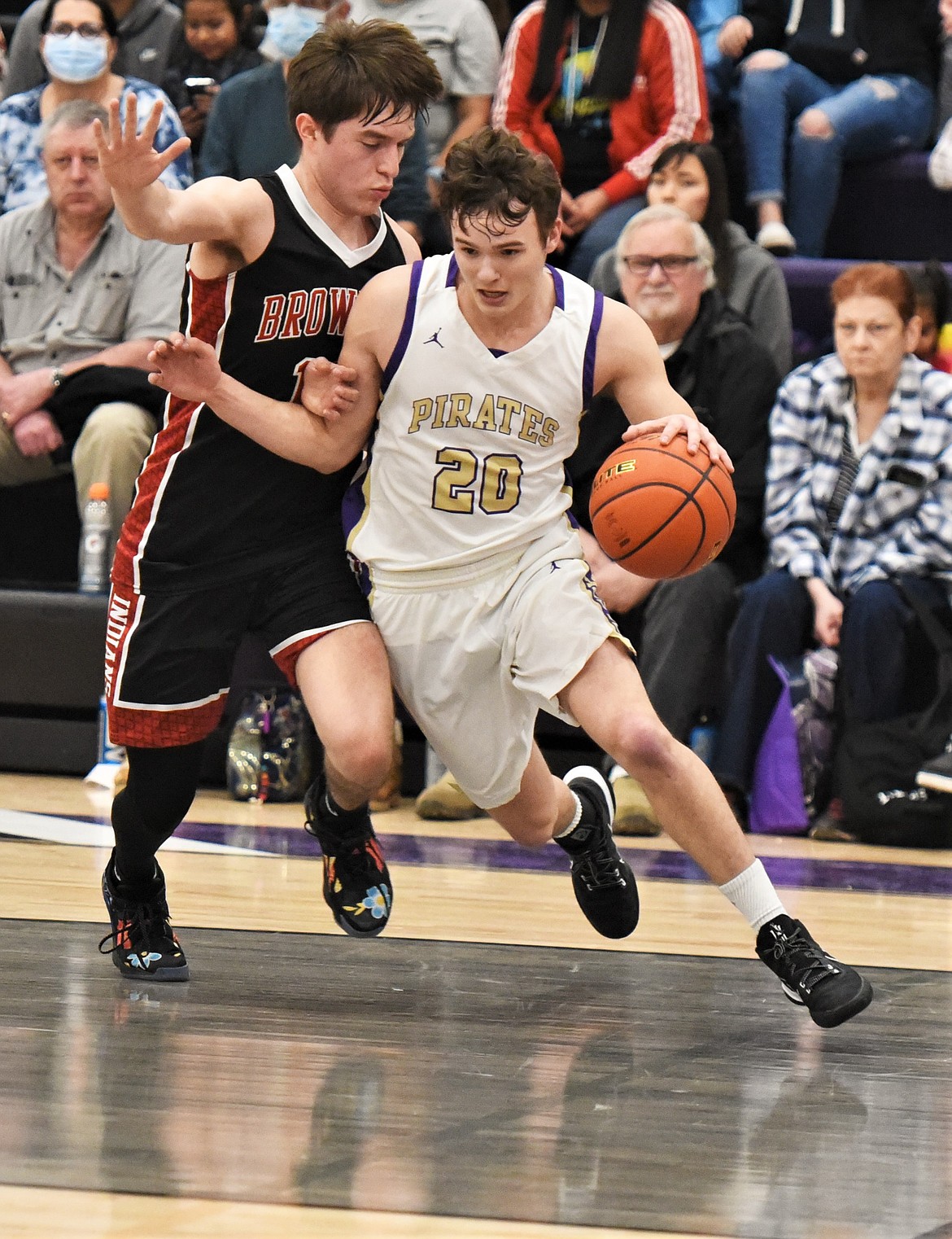 Jarrett Wilson drives the baseline against Browning's Joe Bull Shoe. (Scot Heisel/Lake County Leader)