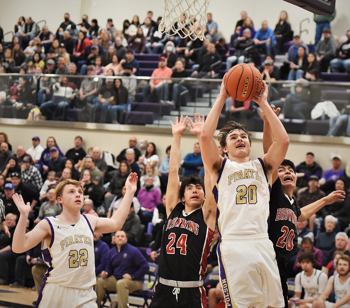 Polson's Jarrett Wilson puts up a shot in front of Browning's Maurice Redhorn III (24) and Jamerson Lazy Boy, and fellow Pirate Trent Wilson. (Scot Heisel/Lake County Leader)