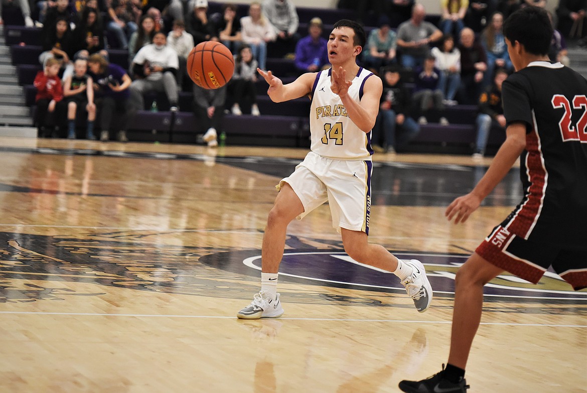 Pirates senior Alex Muzquiz makes a pass in front of Ty Shay Bear Medicine. (Scot Heisel/Lake County Leader)