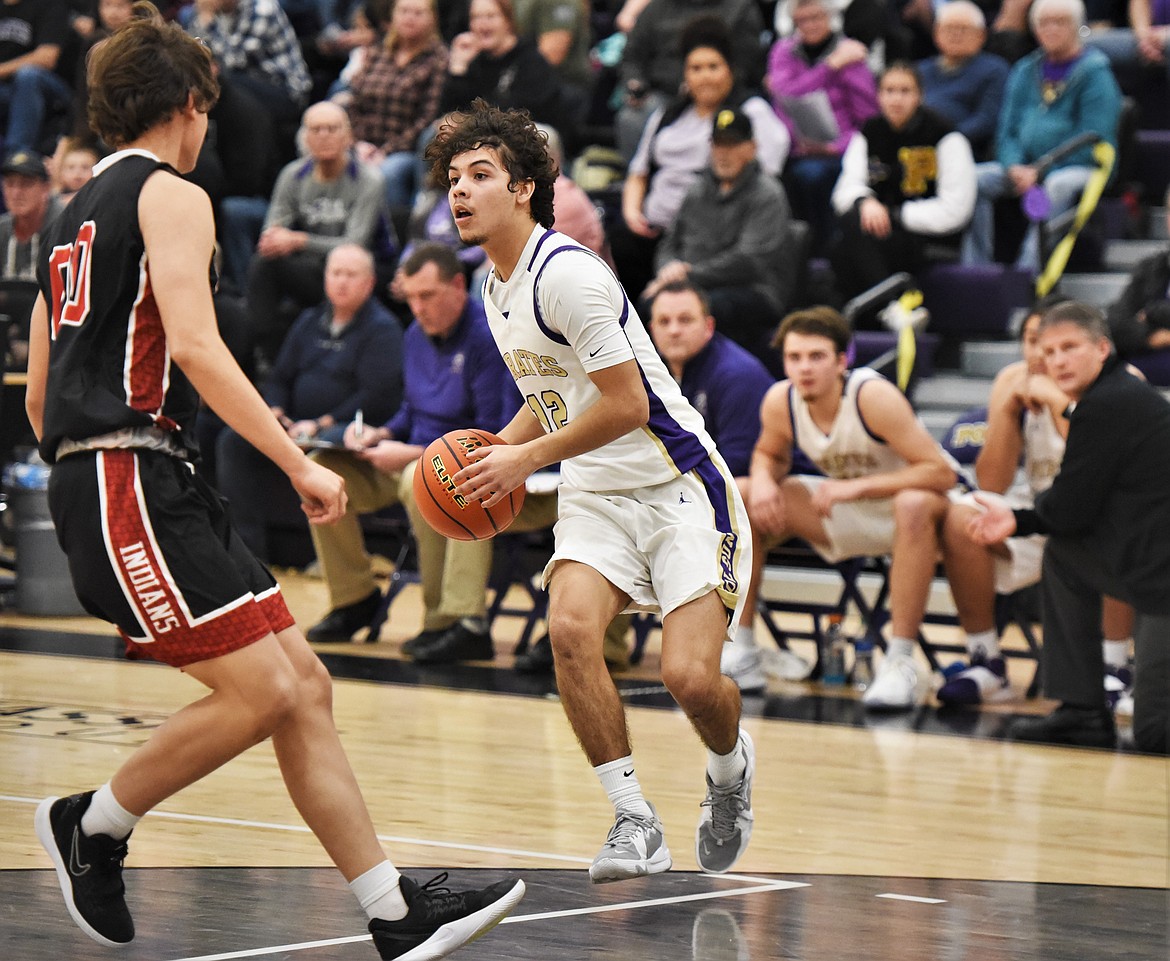 Polson senior Robert Perez drives toward Browning's Delbert Blackman. (Scot Heisel/Lake County Leader)