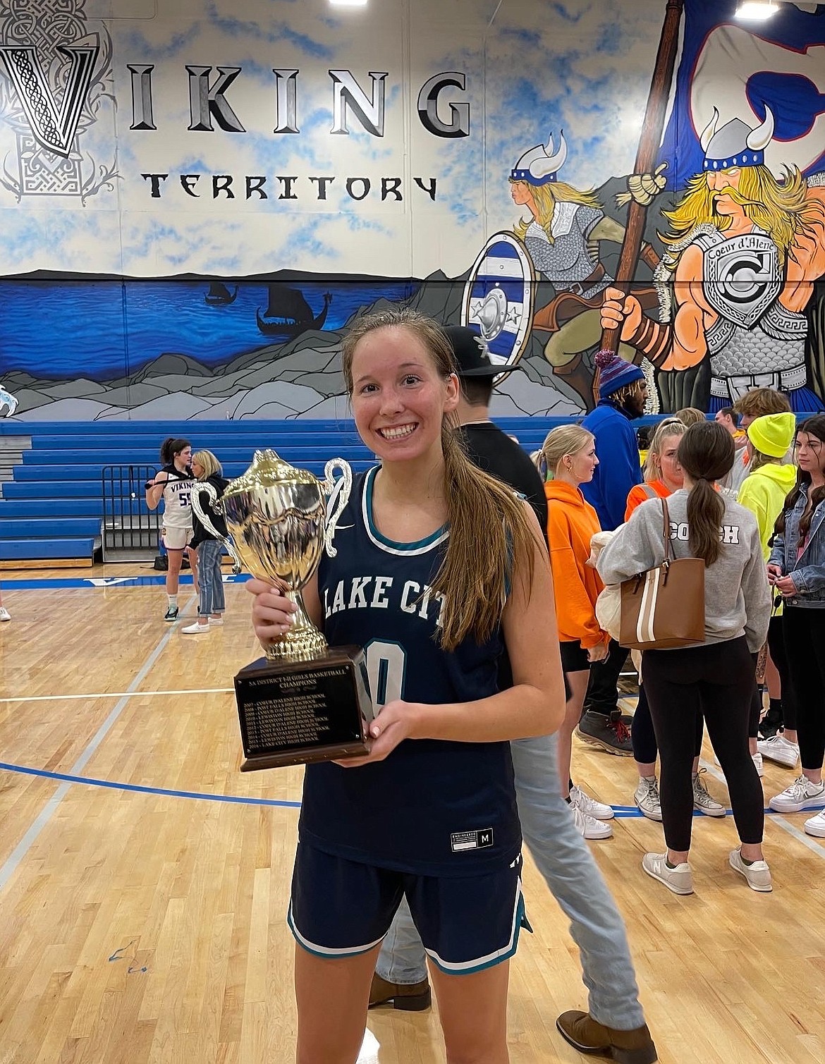 Courtesy photo
Lake City High senior Kendall Pickford holds the 5A Region 1 girls basketball championship trophy following the Timberwolves 63-57 win over Coeur d'Alene on Feb. 8 at Viking Court.