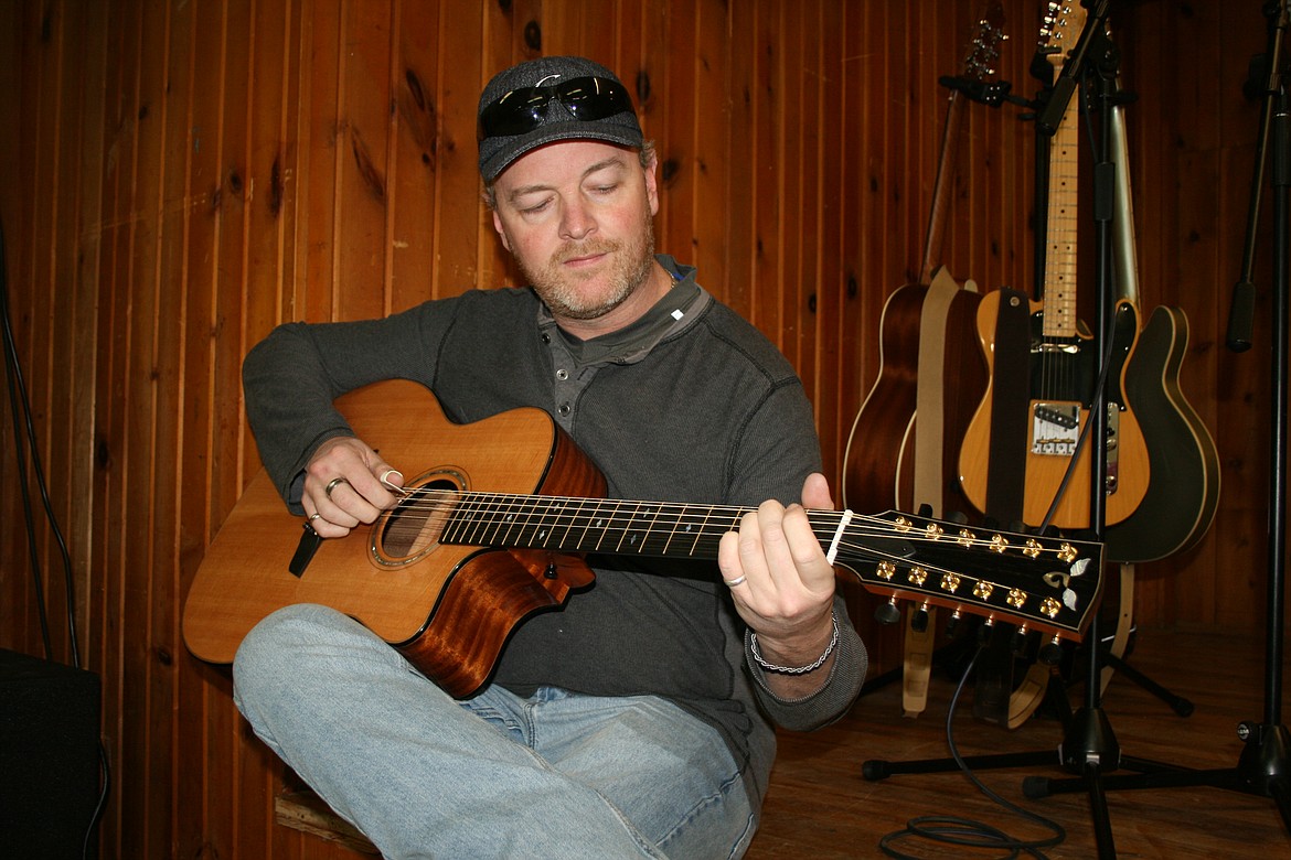 Guitarist Adam Cord warms up on acoustic guitar before a Feb. 12 concert in Moses Lake.