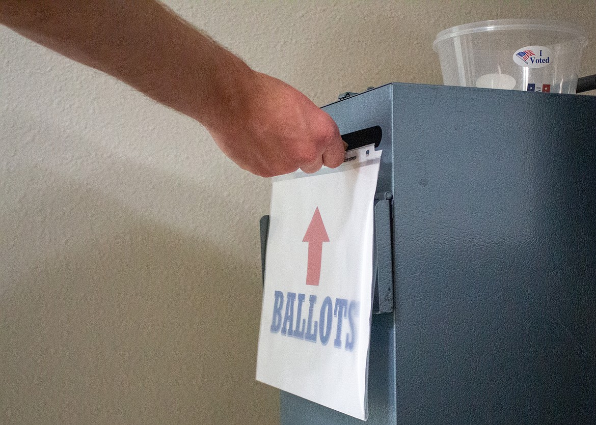 A voter uses a ballot box during the August 2021 election. Updated vote totals from the Feb. 8 special election will be released this afternoon.