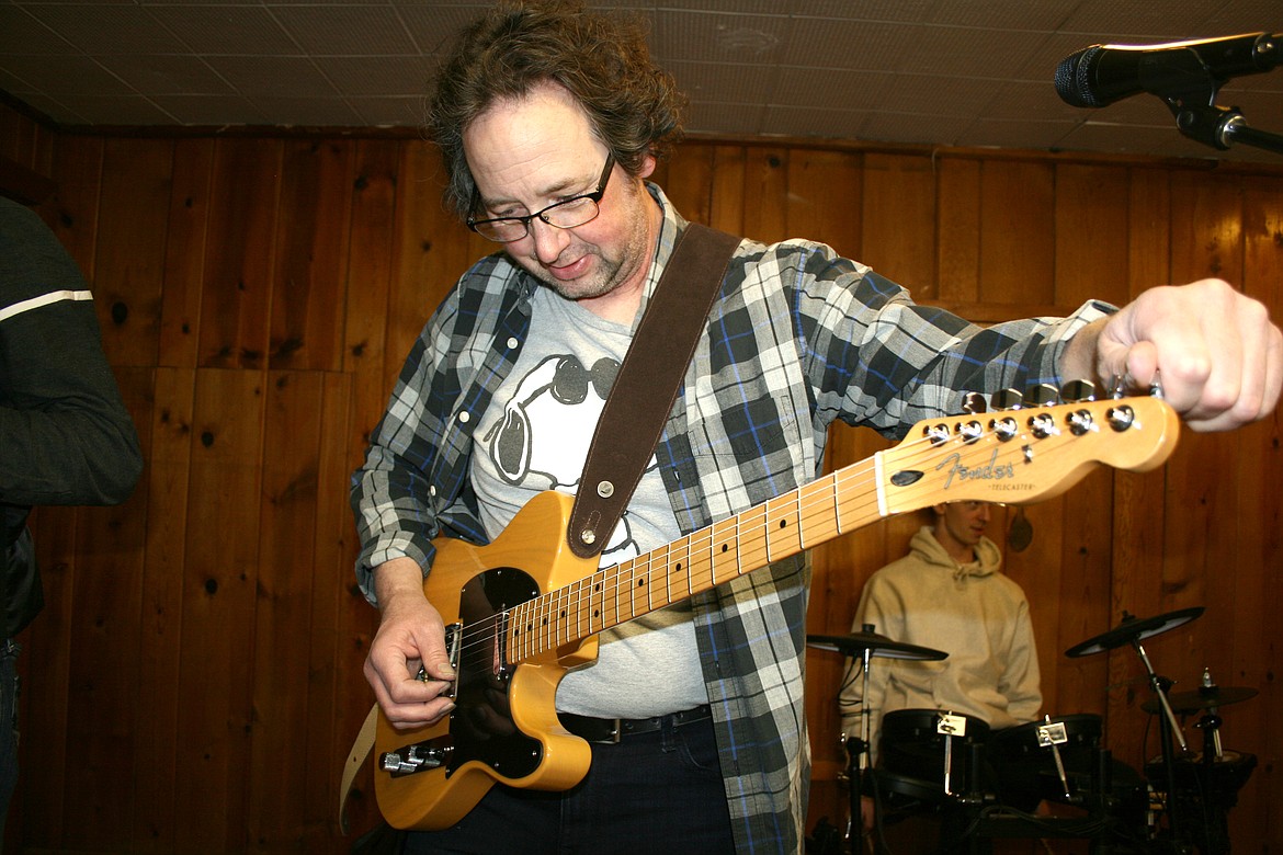 Larry Birger, founder of the Learn from the Masters Music Organization, tunes up before a Feb. 12 concert in Moses Lake.