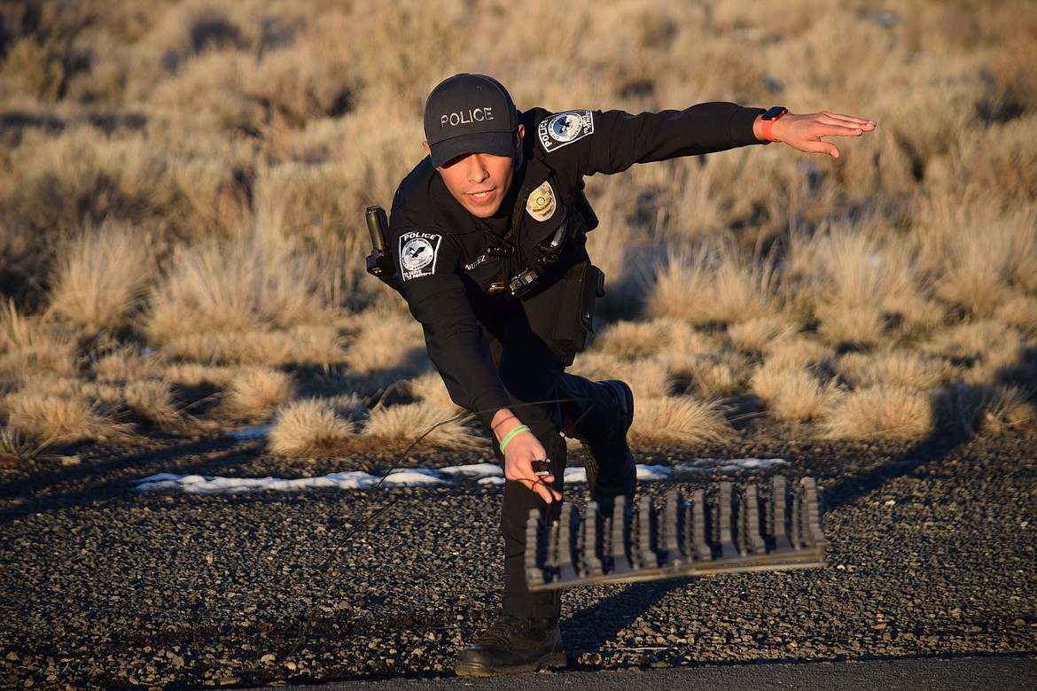 Quincy Police Officer Jerry Martinez practices tossing a spike strip during an afternoon of training. Spike strips can shorten or prevent high-speed chases which can put civilian drivers at risk.