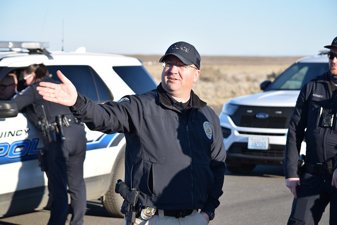 Quincy Police Detective Damon Powell points out the path of the high-speed driving course Quincy Police Department officers will follow during driving exercises on Tuesday.