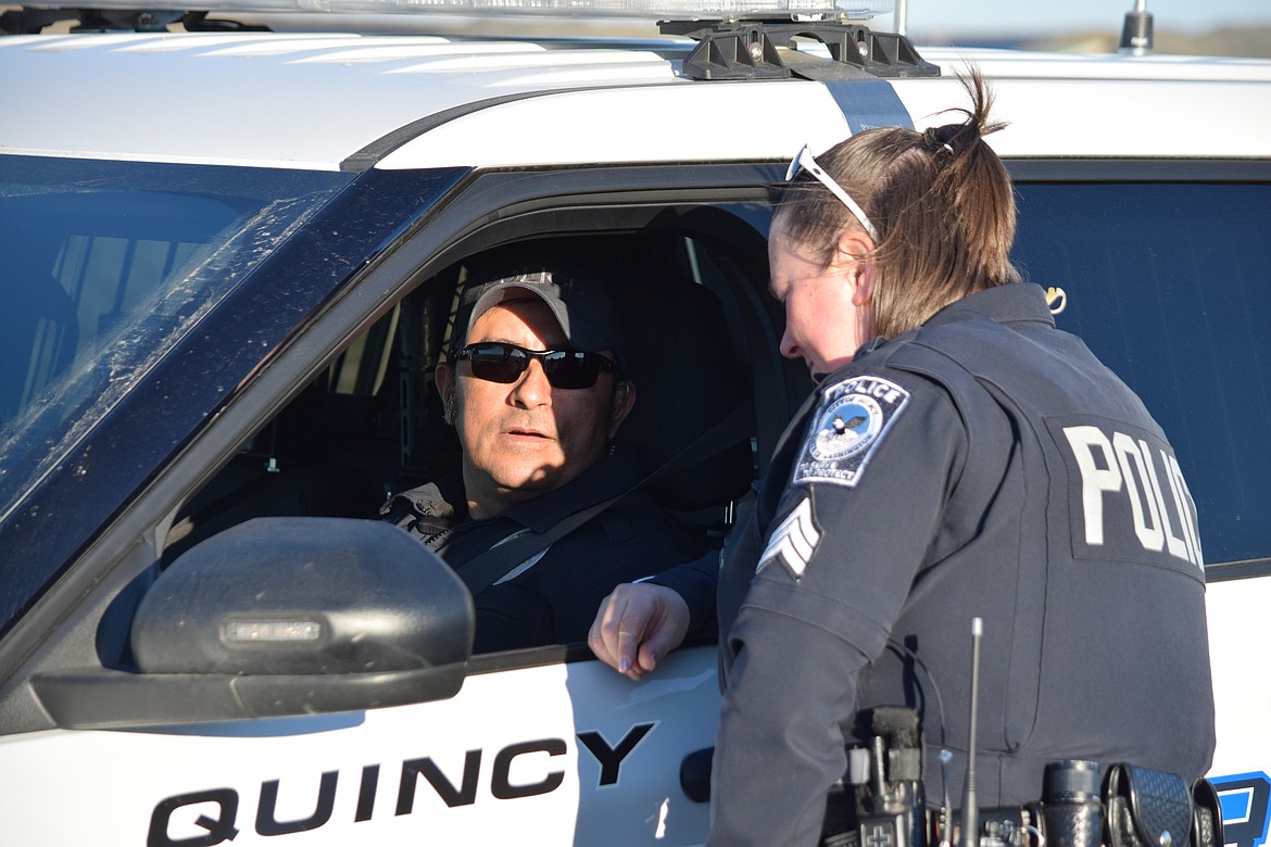 Quincy Police Sgt. Jorge Trujillo talks briefly with Sgt. Julie Fuller prior to driving the Emergency Vehicle Operation Course during Quincy Police Department training.