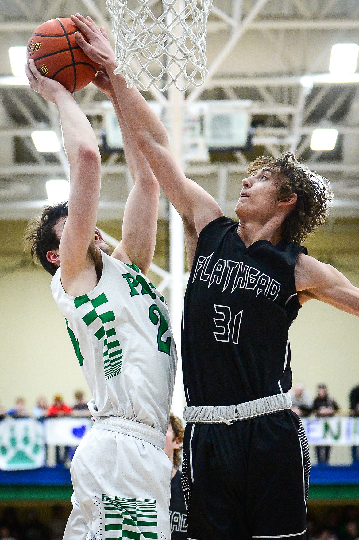 Flathead's Lyric Ersland (31) blocks a shot by Glacier's Noah Dowler (24) at Glacier High School on Thursday, Feb. 17. (Casey Kreider/Daily Inter Lake)