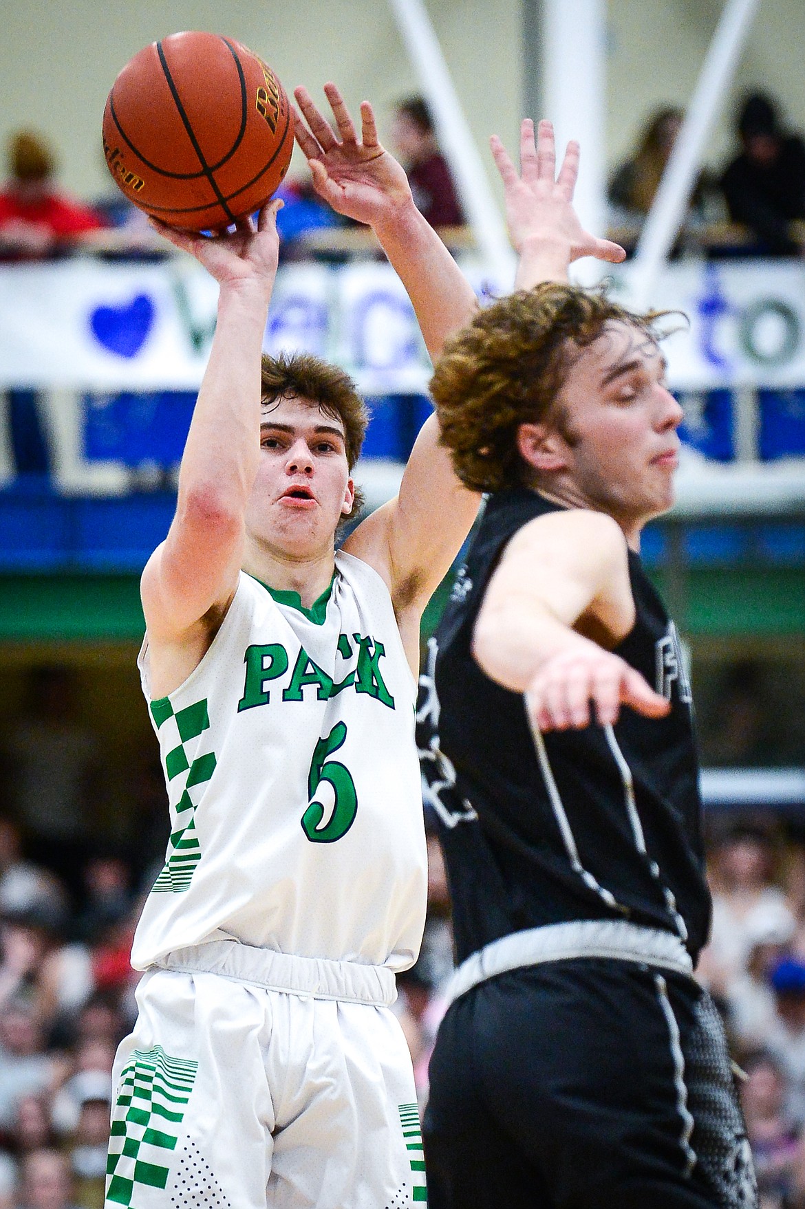 Glacier's Ty Olsen (5) sinks a three guarded by Flathead's Gavin Chouinard (13) at Glacier High School on Thursday, Feb. 17. (Casey Kreider/Daily Inter Lake)