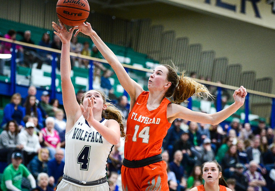 Flathead's Kennedy Moore (14) blocks a shot by Glacier's Colette Daniels (4) at Glacier High School on Thursday, Feb. 17. (Casey Kreider/Daily Inter Lake)