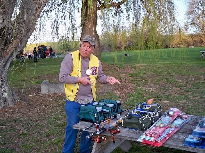 Ephrata Lions member Bill Sangster shows off some of the prizes during the club’s annual fishing derby.