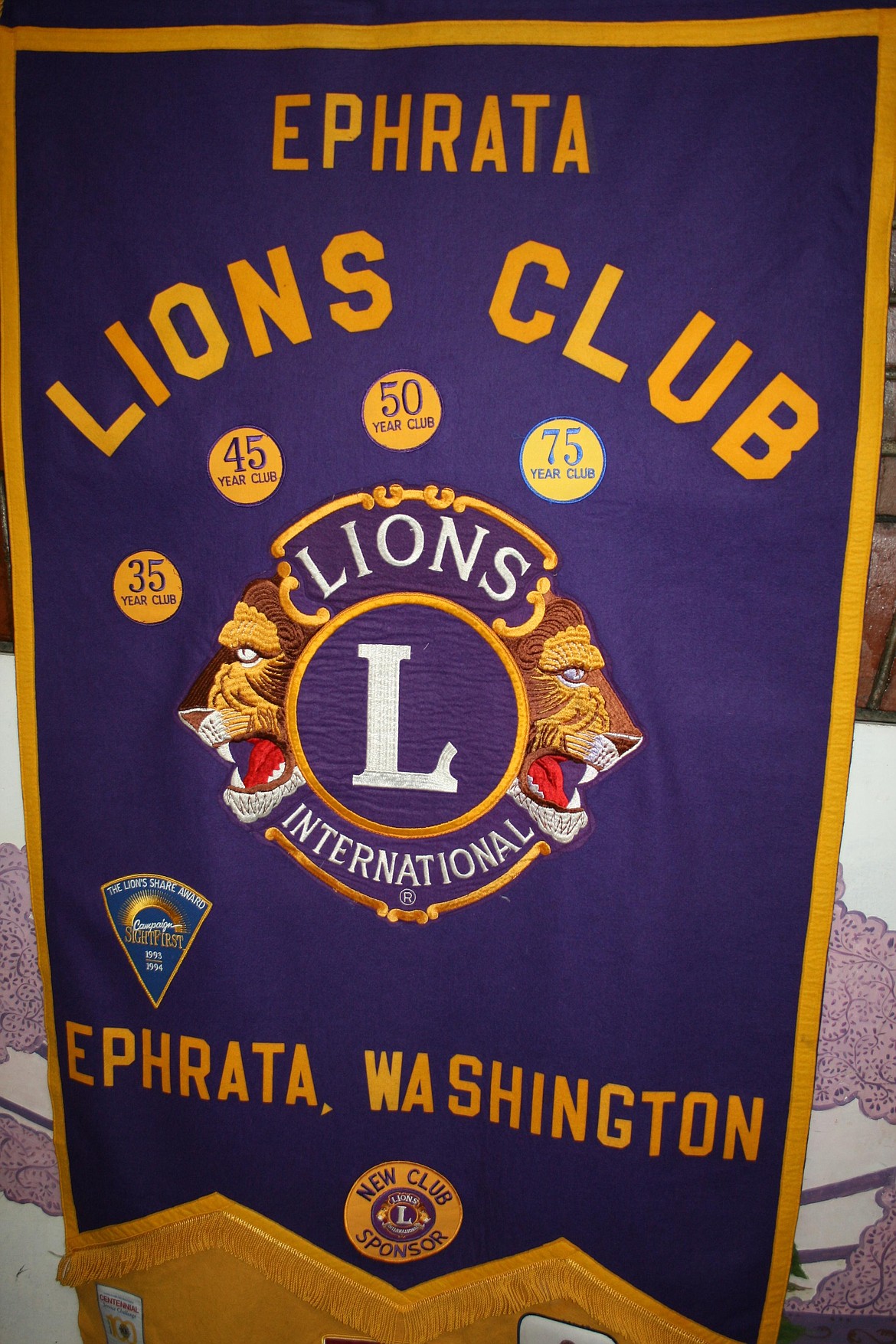 A patch on the Ephrata Lions’ banner commemorates their 75th anniversary, but the club is older than that.