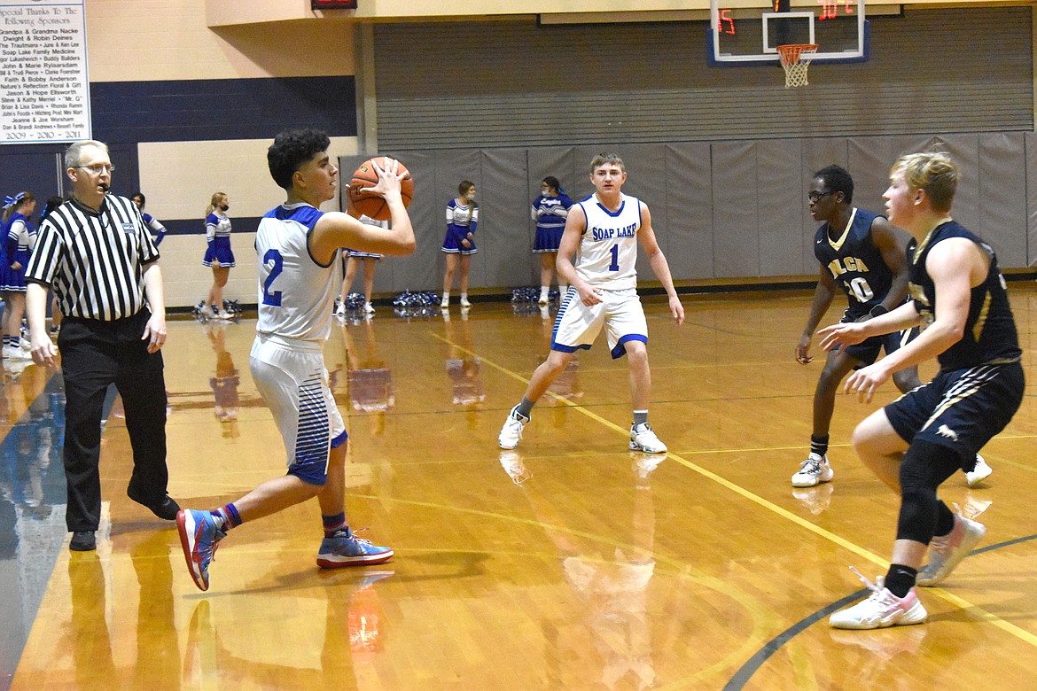 Soap Lake High School senior Diego Garza (2) faces up against two Moses Lake Christian Academy/Covenant Christian School players during their matchup on Dec. 10.