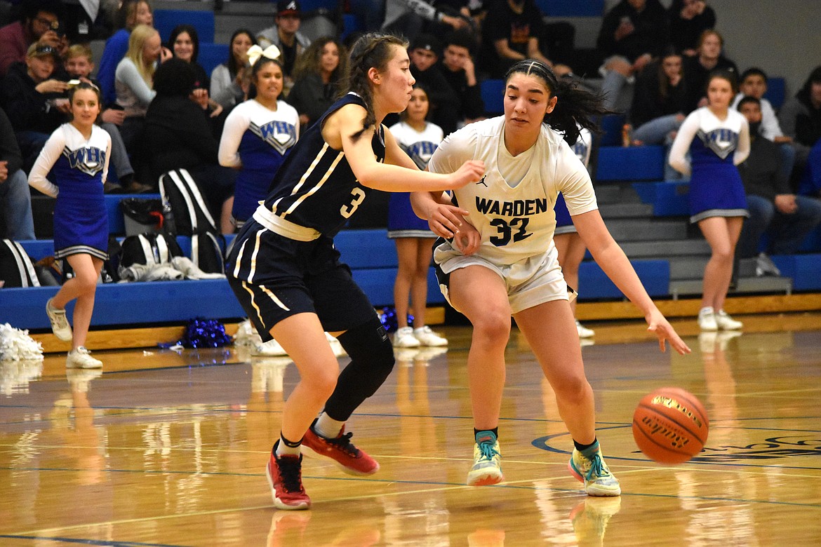 Warden High School senior Kiana Rios (32) drives past Tri-Cities Prep senior Hannah Chang (3) during the district matchup on Feb. 12 at Warden High School.