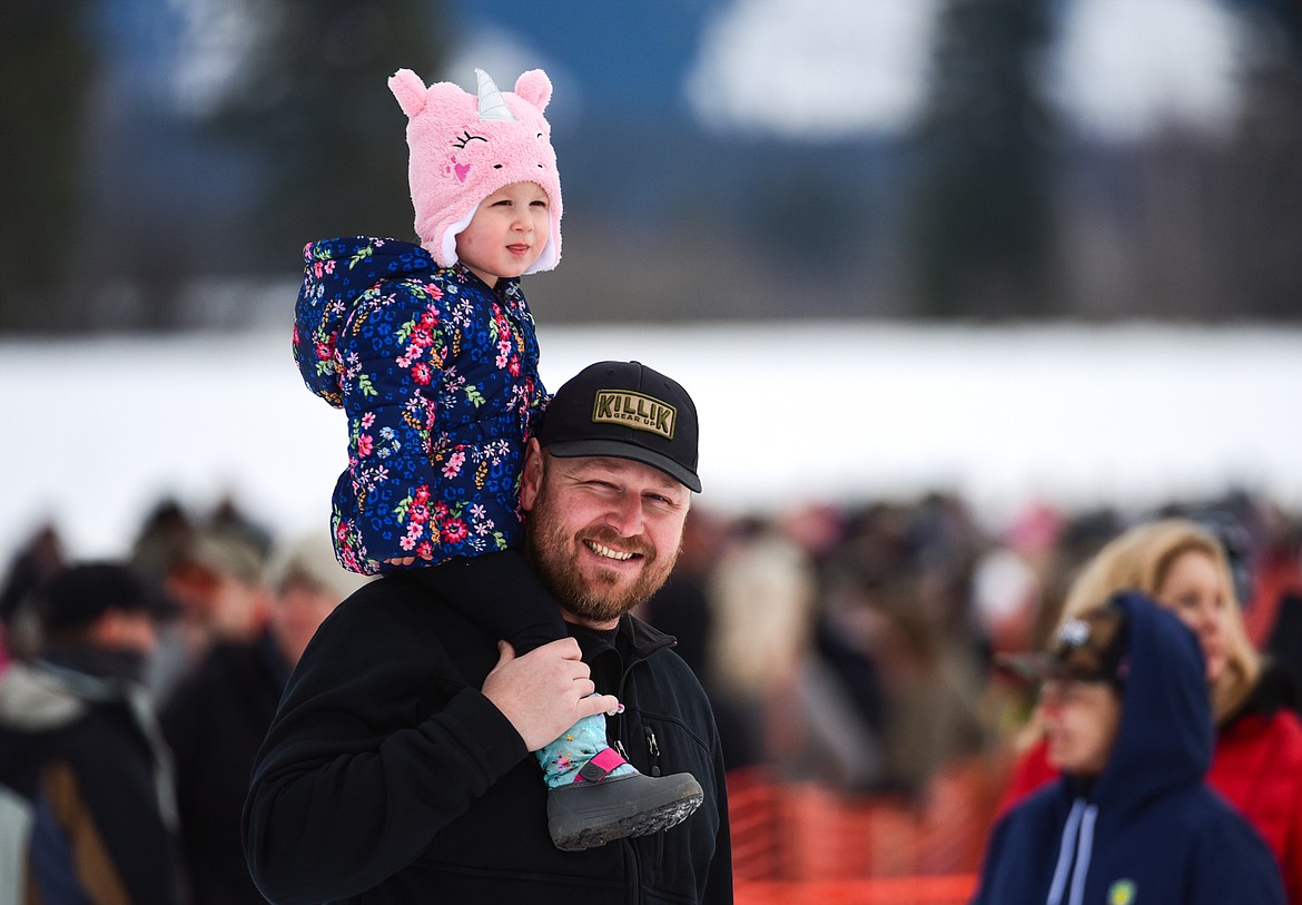 Heidi Burt enjoys a view of the races from her father Brandon's shoulders at Whitefish Ski Joring on Saturday, Feb. 19. (Casey Kreider/Daily Inter Lake)