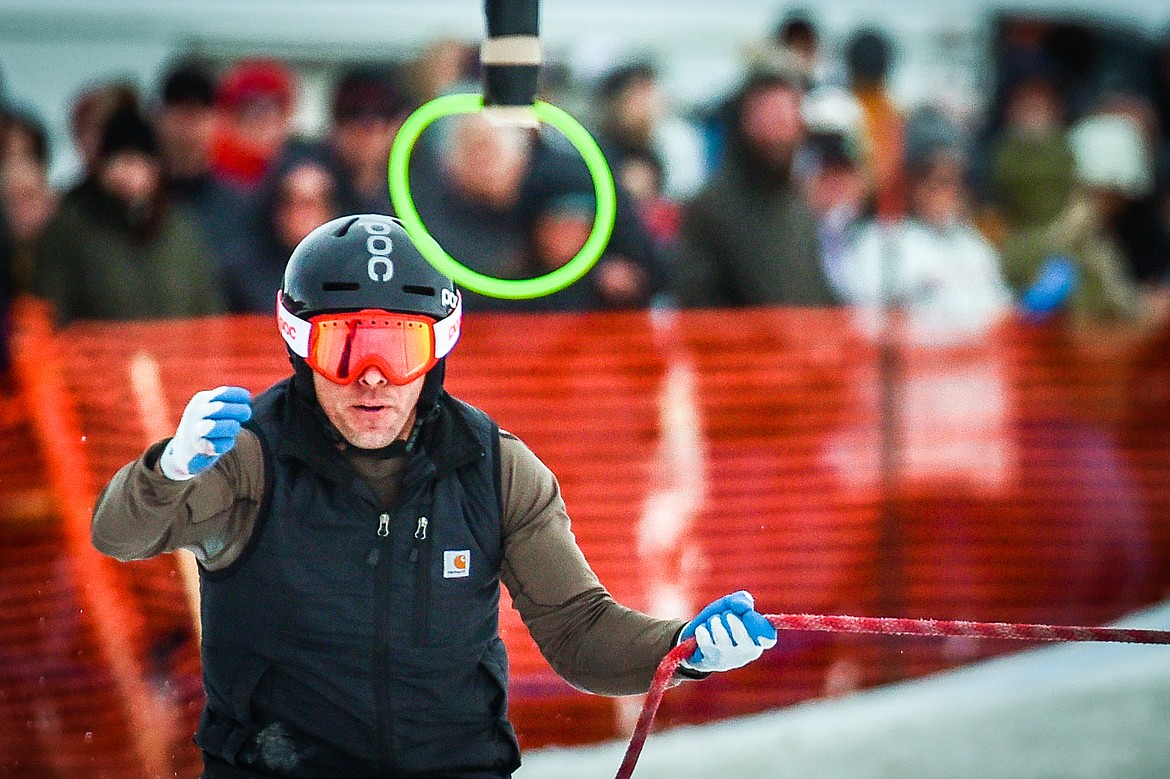 A skier reaches for a ring as he is pulled through the course during Whitefish Ski Joring on Saturday, Feb. 19. (Casey Kreider/Daily Inter Lake)