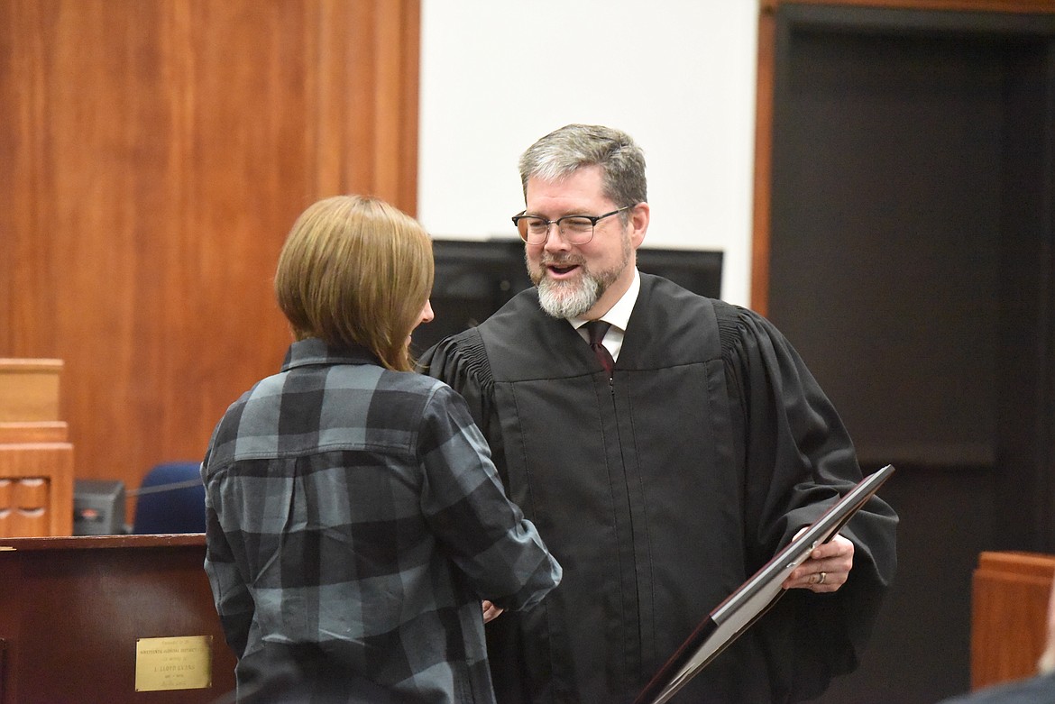 District Judge Matthew Cuffe congratulates Chelsea Faber on Feb. 18. (Derrick Perkins/The Western News)