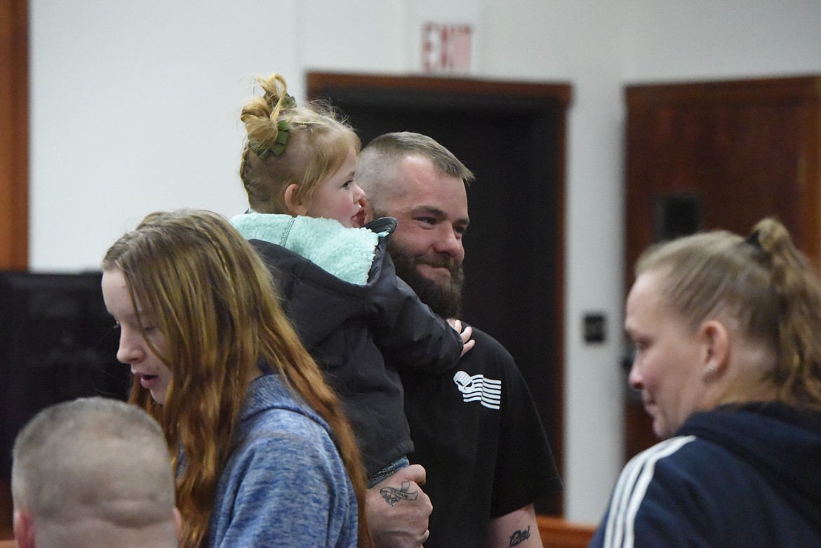 Thomas Eaker celebrates with his daughter after graduating from Lincoln County District Court on Feb. 18. (Derrick Perkins/The Western News)
