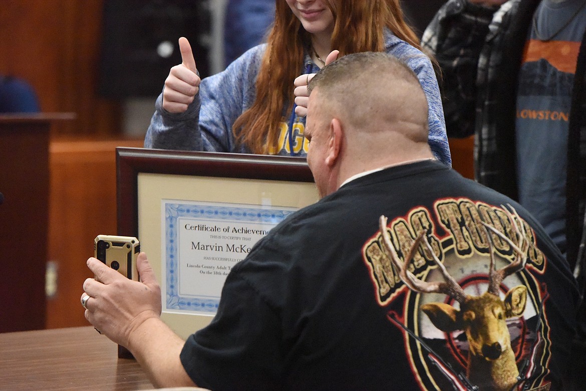 Marvin McKeever shows his treatment court completion certificate to a relative via Facetime. (Derrick Perkins/The Western News)