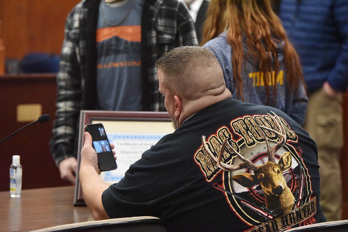 Marvin McKeever celebrates with a relative via Facetime after graduating from Lincoln County Treatment Court on Feb. 18. (Derrick Perkins/The Western News)