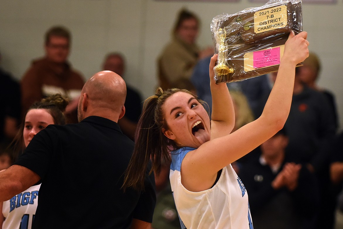 Bigfork's Emma Berreth celebrates with the trophy after the Valkyries captured the District 7B Tournament championship at home Saturday. (Jeremy Weber/Daily Inter Lake