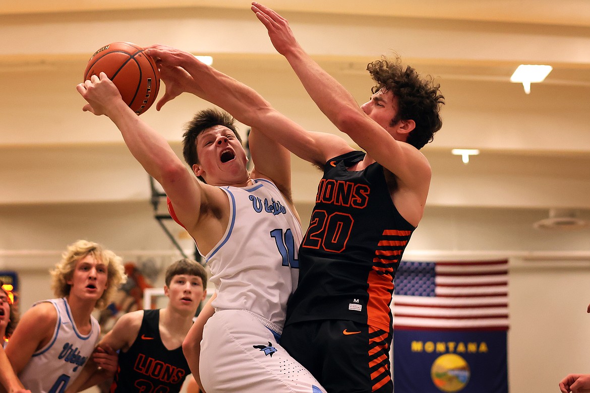 Bigfork's Levi Taylor is fouled by Eureka's Gavin Bates during action in the District 7B title game Saturday. (Jeremy Weber/Daily Inter Lake)